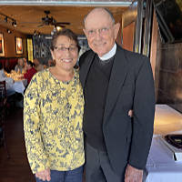 Father Fred with a plaque